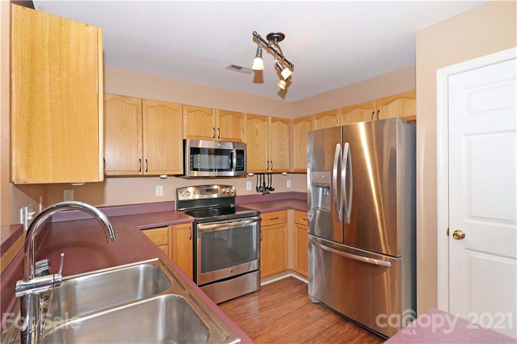 120 Cinebar Road Mooresville, NC 28115 - Photo 11 of 36 a kitchen with stainless steel appliances granite countertop a refrigerator a stove top oven a sink and dishwasher