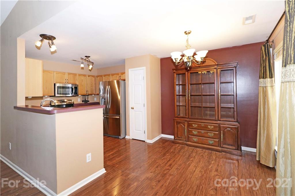 120 Cinebar Road Mooresville, NC 28115 - Photo 12 of 36 a view of kitchen with furniture wooden floor and a ceiling fan