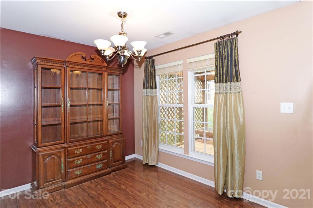120 Cinebar Road Mooresville, NC 28115 - Photo 13 of 36 a view of a livingroom with wooden floor and windows