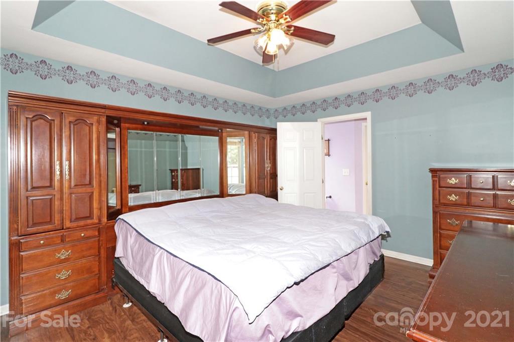 120 Cinebar Road Mooresville, NC 28115 - Photo 14 of 36 a bedroom with a large bed and a chandelier