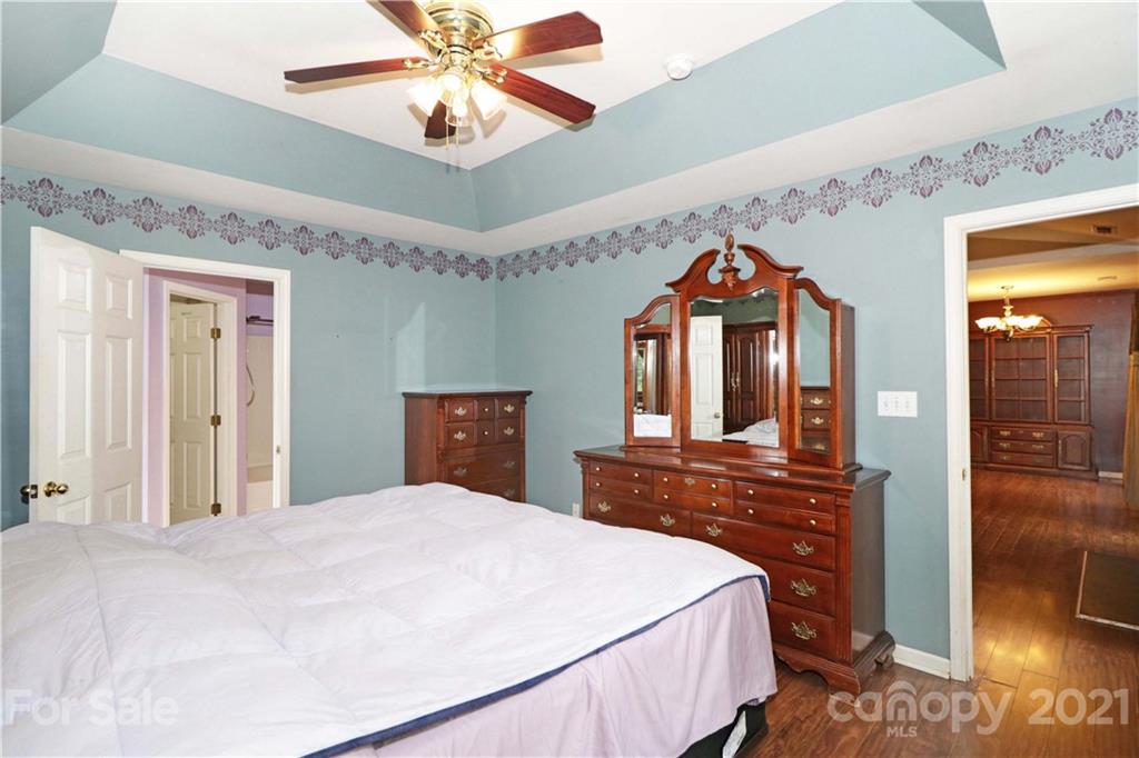120 Cinebar Road Mooresville, NC 28115 - Photo 16 of 36 a bedroom with a bed and a mirror on the dresser