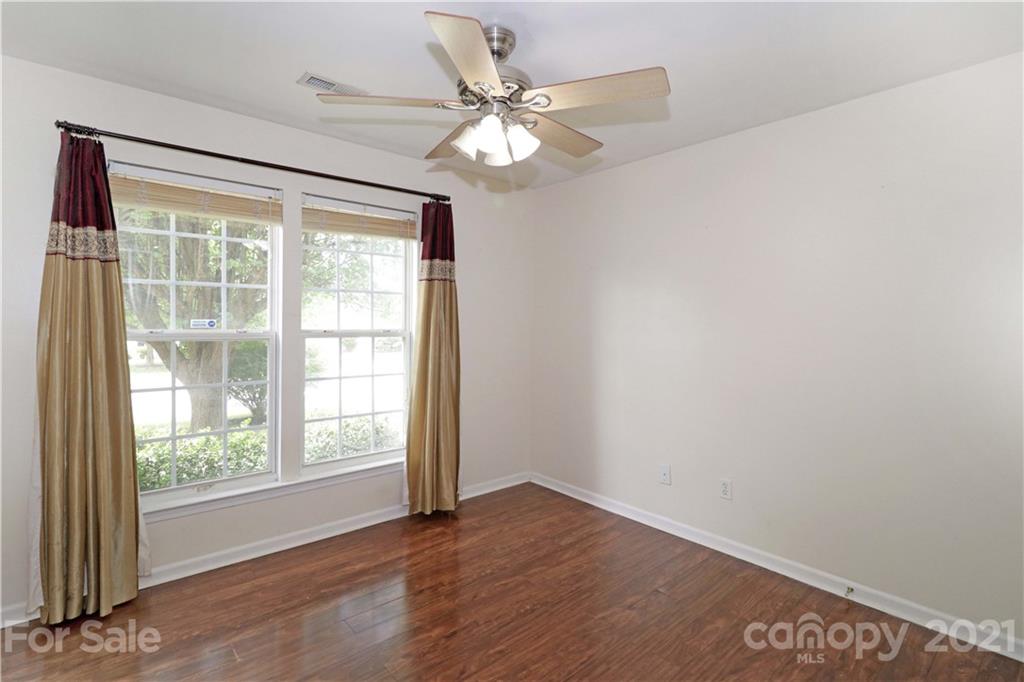 120 Cinebar Road Mooresville, NC 28115 - Photo 20 of 36 an empty room with wooden floor and windows