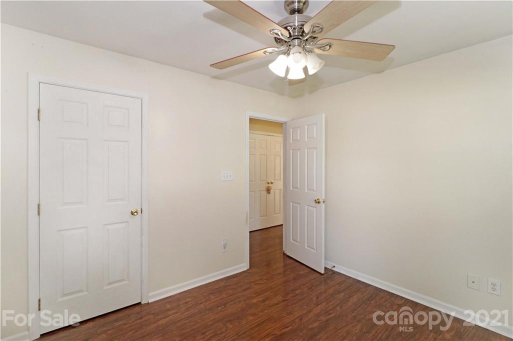 120 Cinebar Road Mooresville, NC 28115 - Photo 21 of 36 an empty room with wooden floor and ceiling fan