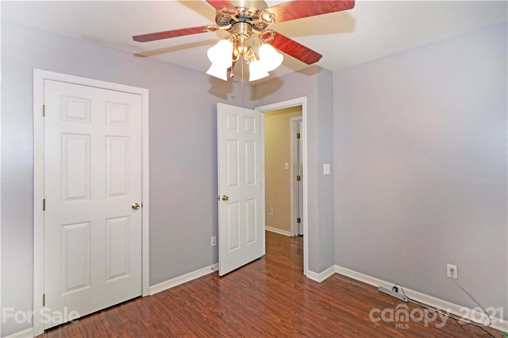 120 Cinebar Road Mooresville, NC 28115 - Photo 25 of 36 wooden floor in an empty room with a chandelier fan