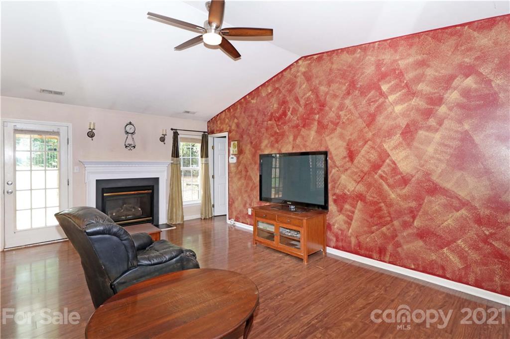 120 Cinebar Road Mooresville, NC 28115 - Photo 5 of 36 a living room with furniture and a flat screen tv