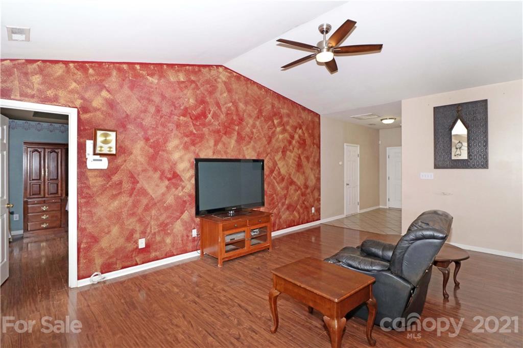 120 Cinebar Road Mooresville, NC 28115 - Photo 6 of 36 a living room with furniture and a flat screen tv