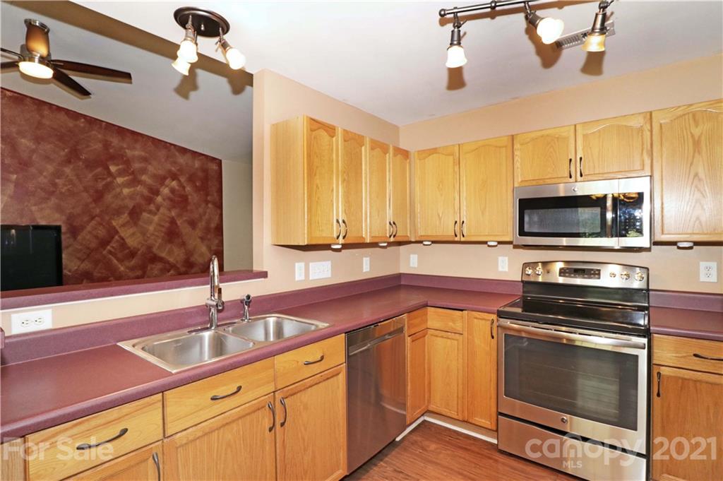 120 Cinebar Road Mooresville, NC 28115 - Photo 9 of 36 a kitchen with granite countertop a sink stainless steel appliances and cabinets