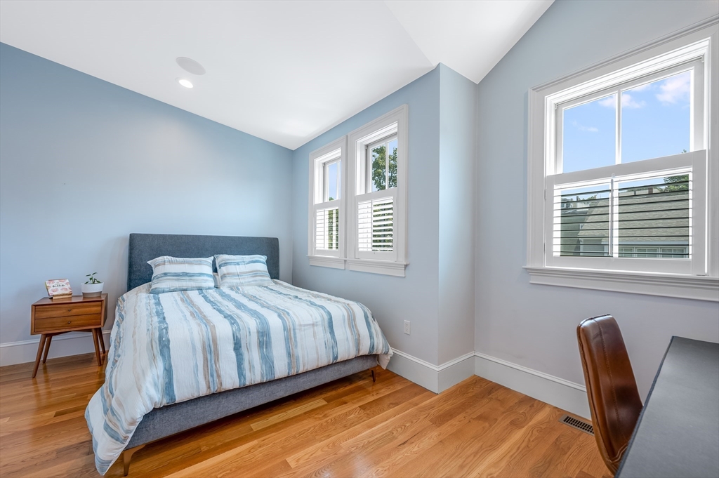 480 East 4th Street, Unit 3 Boston, MA 02127 - Photo 14 of 25 a bedroom with a bed a table and chair