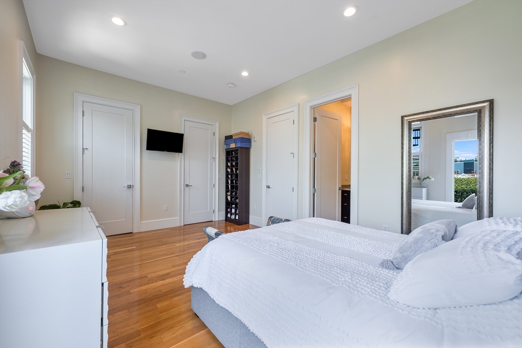 480 East 4th Street, Unit 3 Boston, MA 02127 - Photo 15 of 25 a bedroom with a bed and a flat screen tv