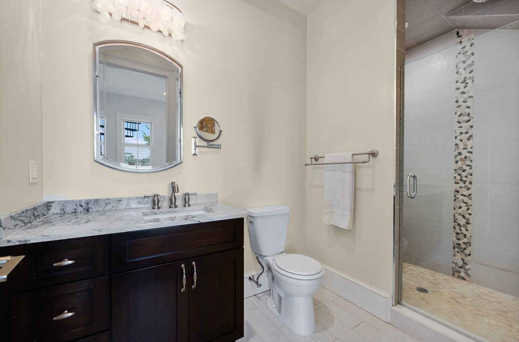480 East 4th Street, Unit 3 Boston, MA 02127 - Photo 18 of 25 a bathroom with a toilet a sink a mirror and shower