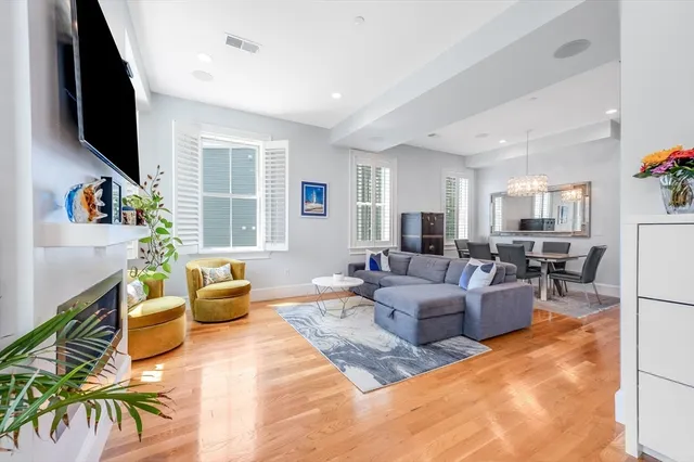a living room with fireplace furniture and a flat screen tv