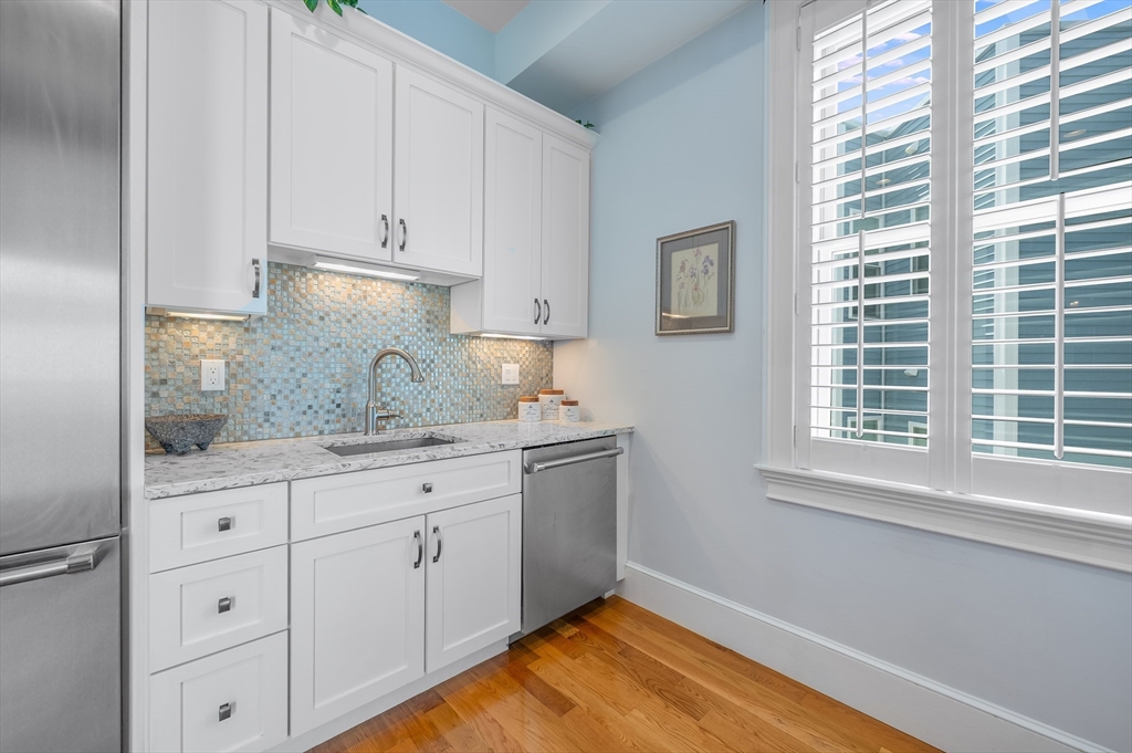480 East 4th Street, Unit 3 Boston, MA 02127 - Photo 8 of 25 a kitchen with granite countertop white cabinets and a window