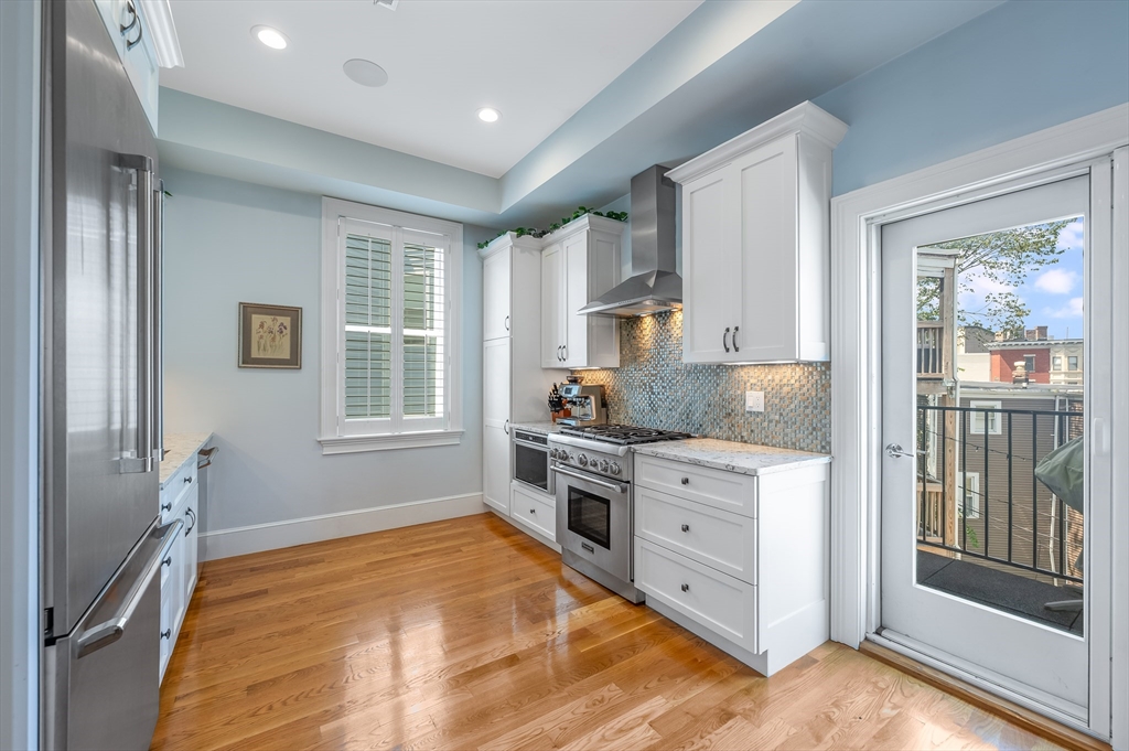 480 East 4th Street, Unit 3 Boston, MA 02127 - Photo 9 of 25 a kitchen with stainless steel appliances granite countertop a stove and a refrigerator