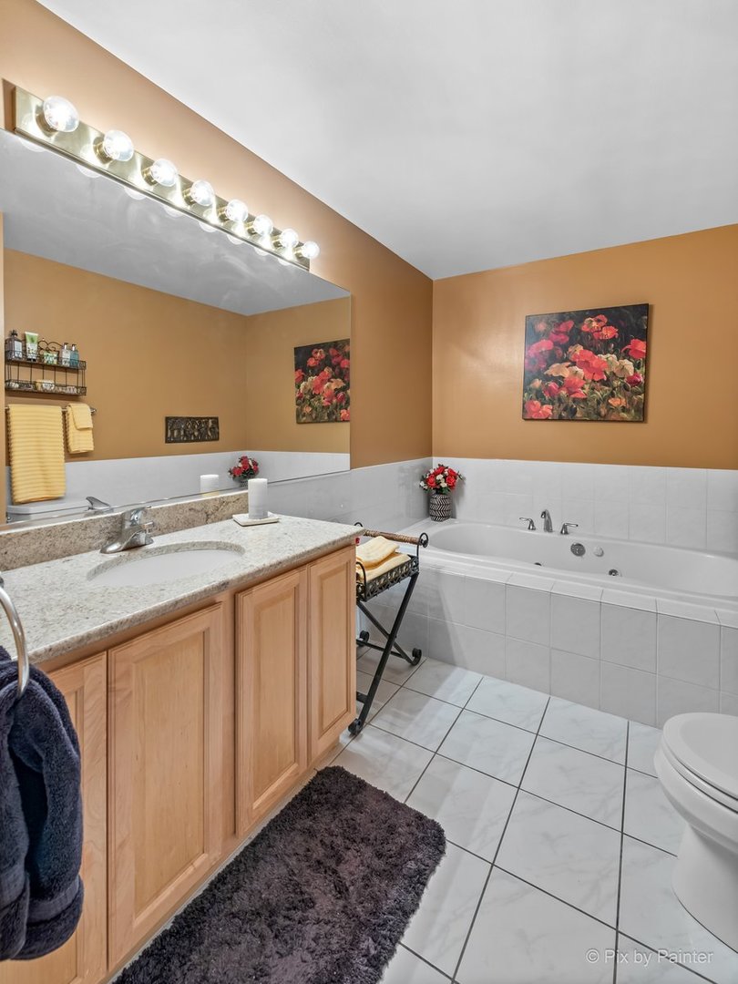 1 Renaissance Place, Unit GF7 Palatine, IL 60067 - Photo 14 of 28 a spacious bathroom with a sink a mirror and a bathtub