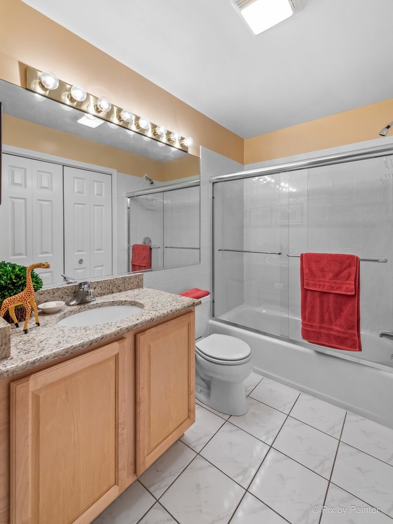 1 Renaissance Place, Unit GF7 Palatine, IL 60067 - Photo 18 of 28 a bathroom with a toilet sink and mirror