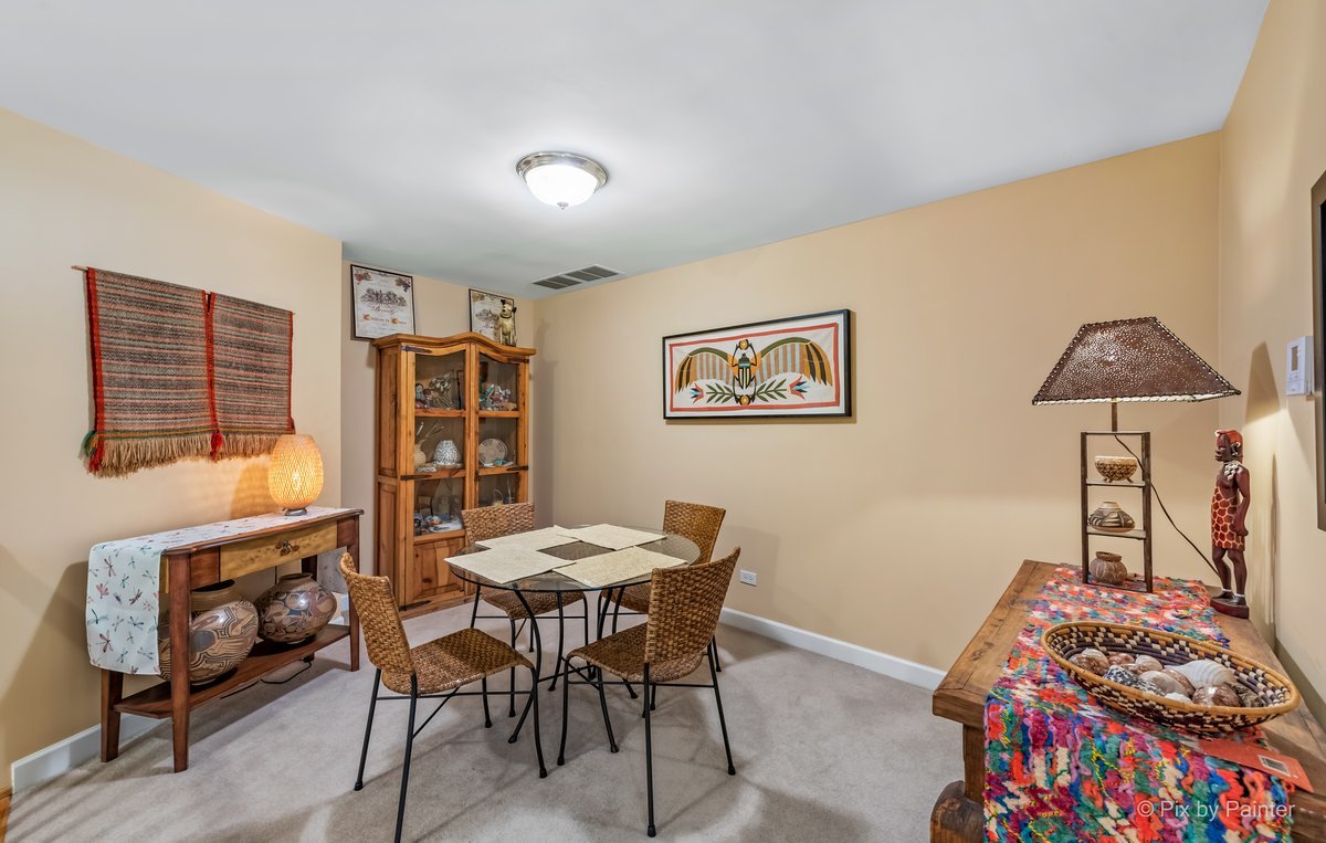 1 Renaissance Place, Unit GF7 Palatine, IL 60067 - Photo 9 of 28 a bedroom with a baby bed a desk and chair with rug