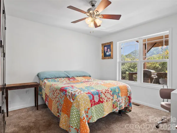 a bedroom with a bed and a large window