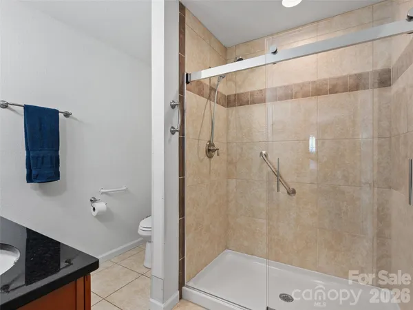a bathroom with a shower and a sink