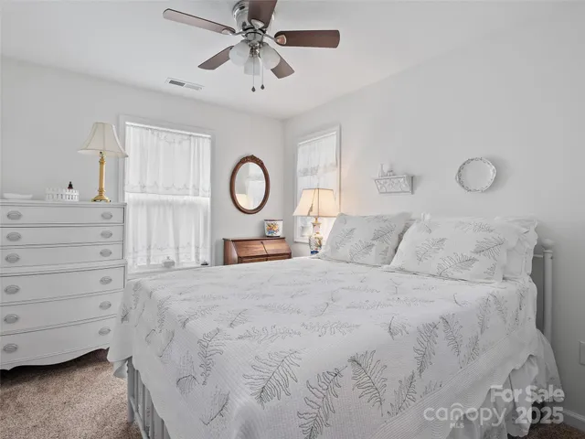 a bed room with a bed and a chandelier