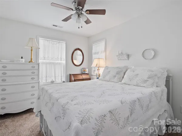 a bed room with a bed and a chandelier