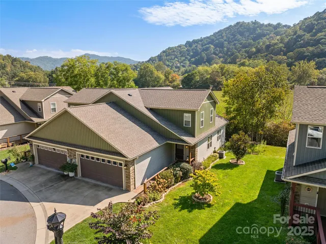an aerial view of a house with a yard