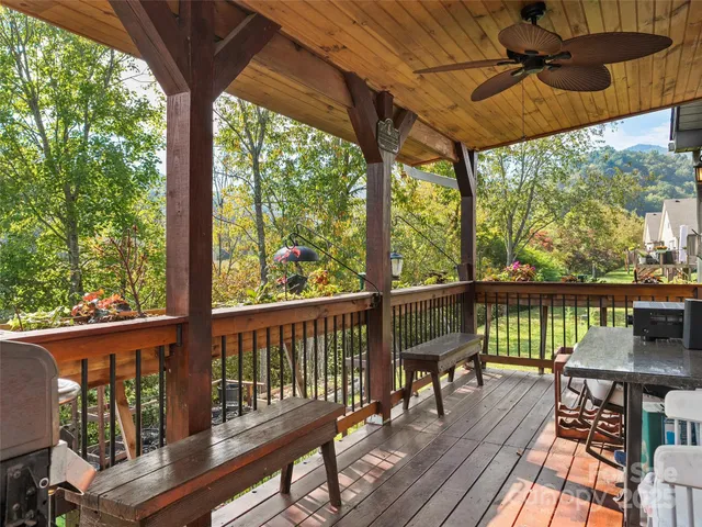 a view of a balcony with furniture and wooden floor