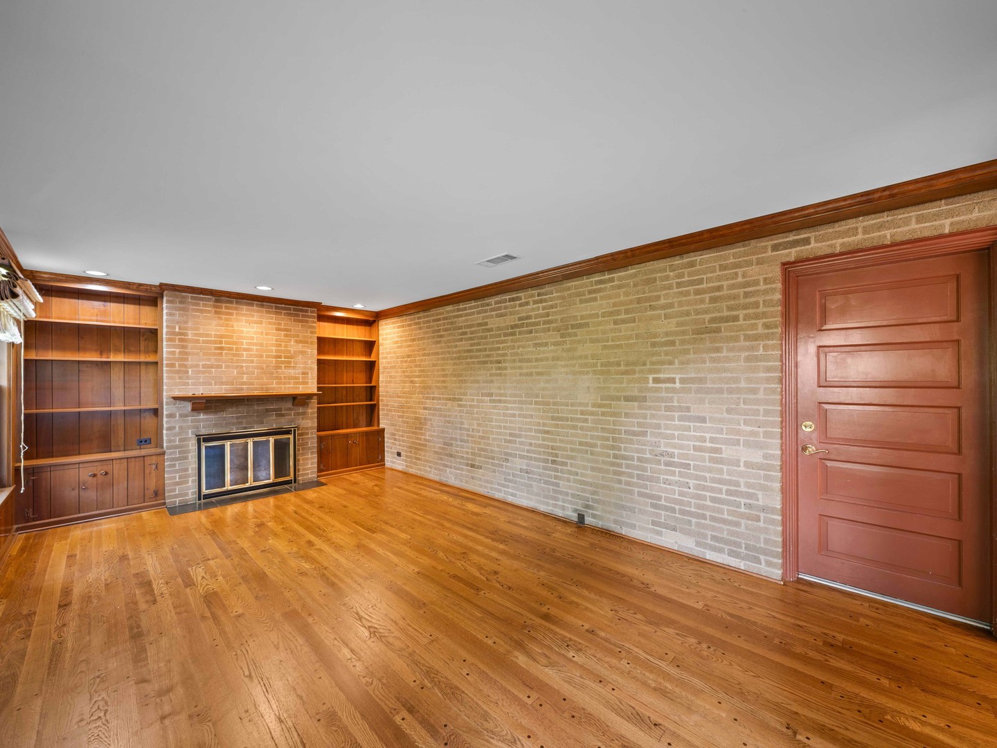 1125 Golfview Road Glenview, IL 60025 - Photo 17 of 44 a view of an empty room with a window and wooden floor