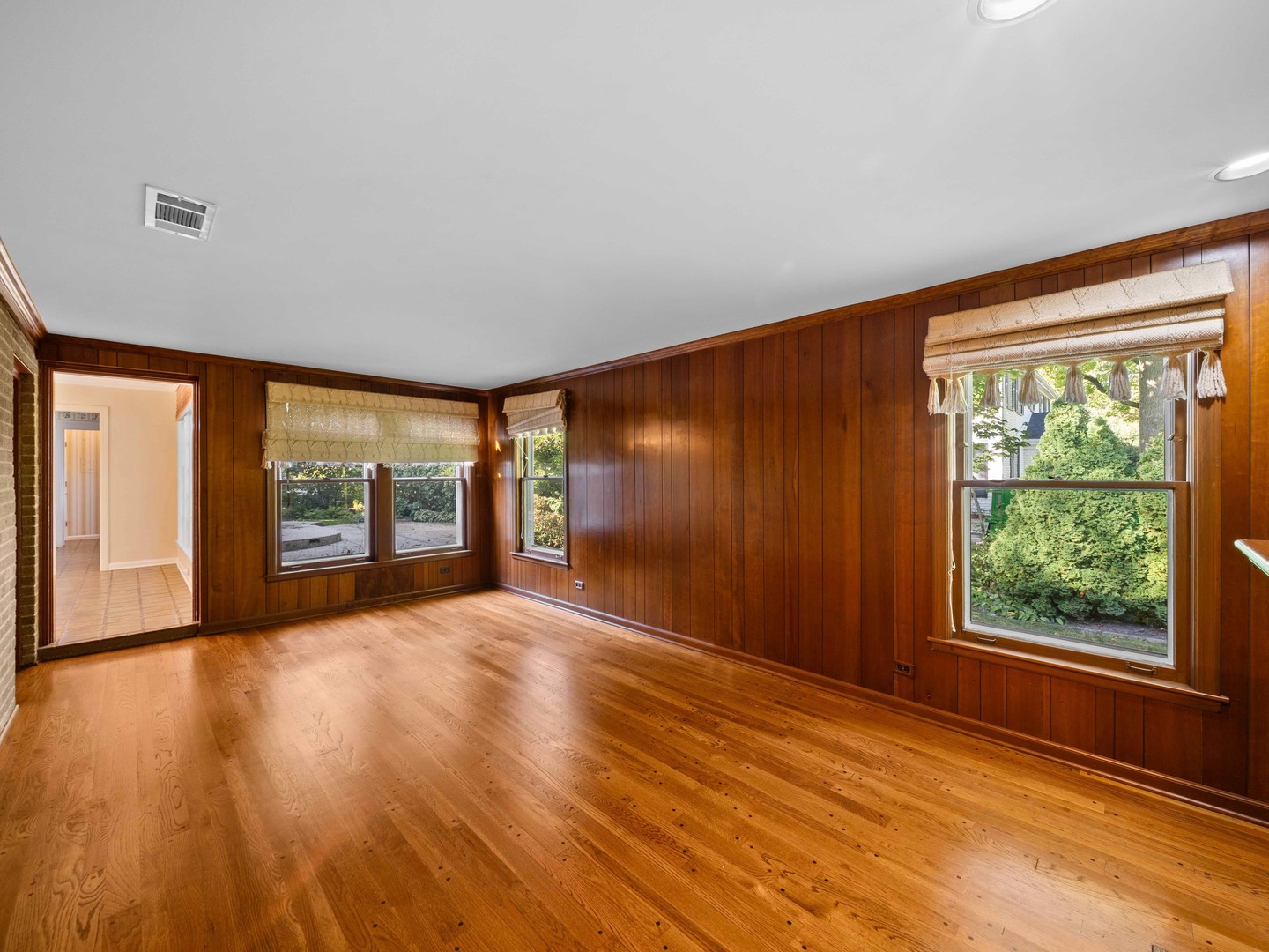 1125 Golfview Road Glenview, IL 60025 - Photo 20 of 44 a view of an empty room with a window and wooden floor