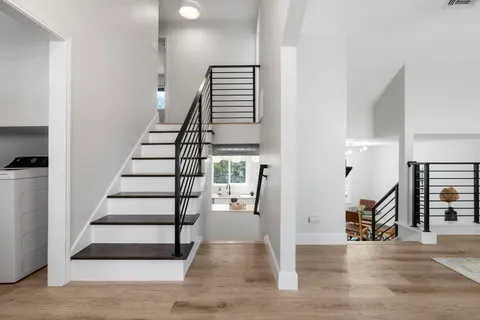 a view of entryway and hall with wooden floor