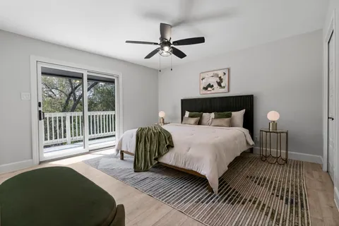 a bedroom with a bed and a large window
