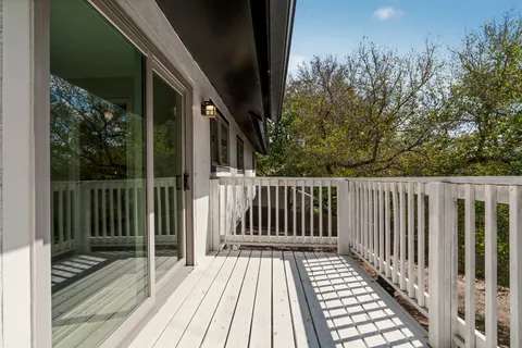 a view of backyard with wooden floor and fence