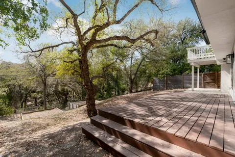 a view of a backyard with wooden fence