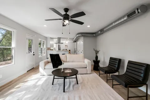 a living room with furniture and a wooden floor
