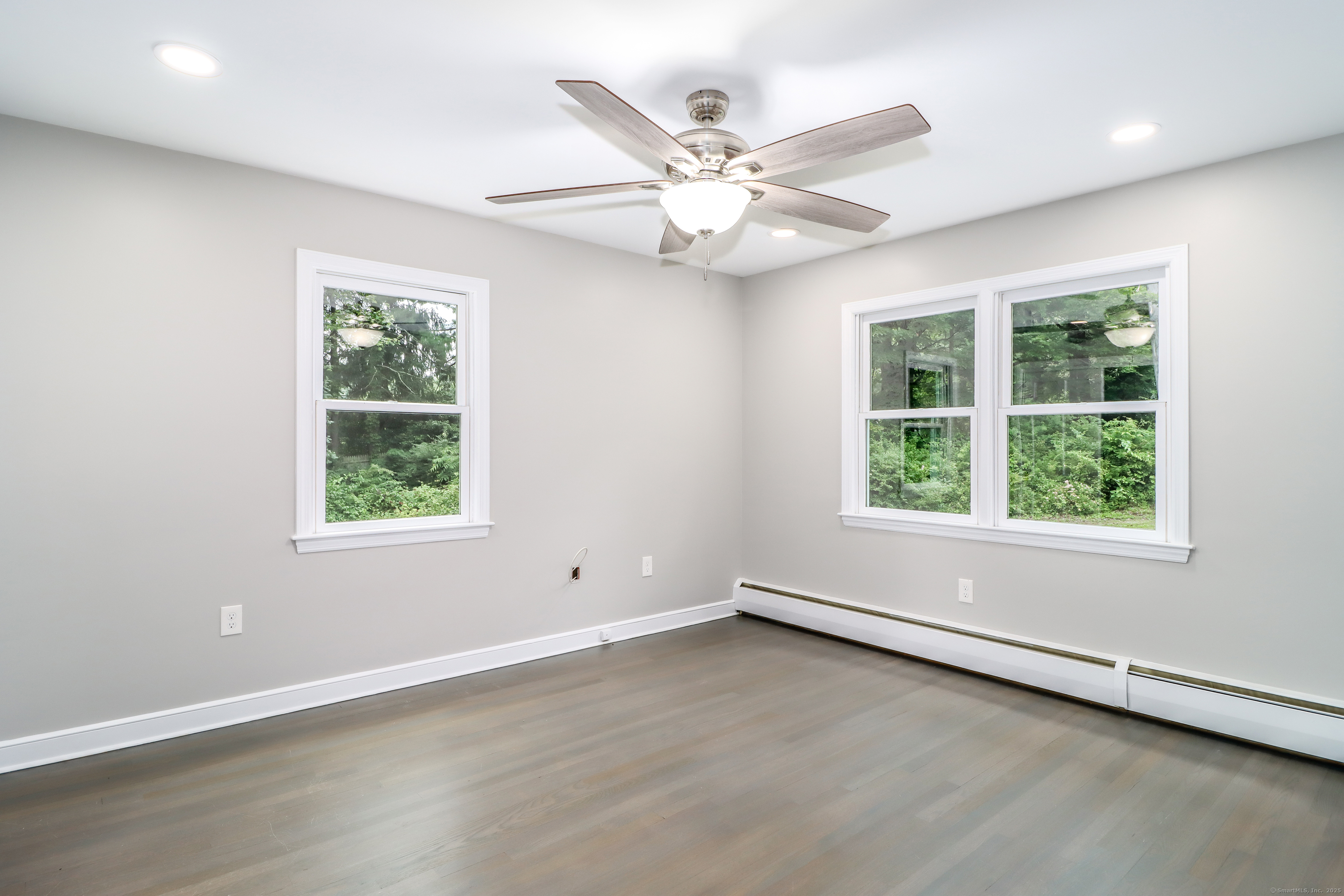 22 Lonetown Road Redding, CT 06896 - Photo 25 of 37 an empty room with wooden floor fan and windows