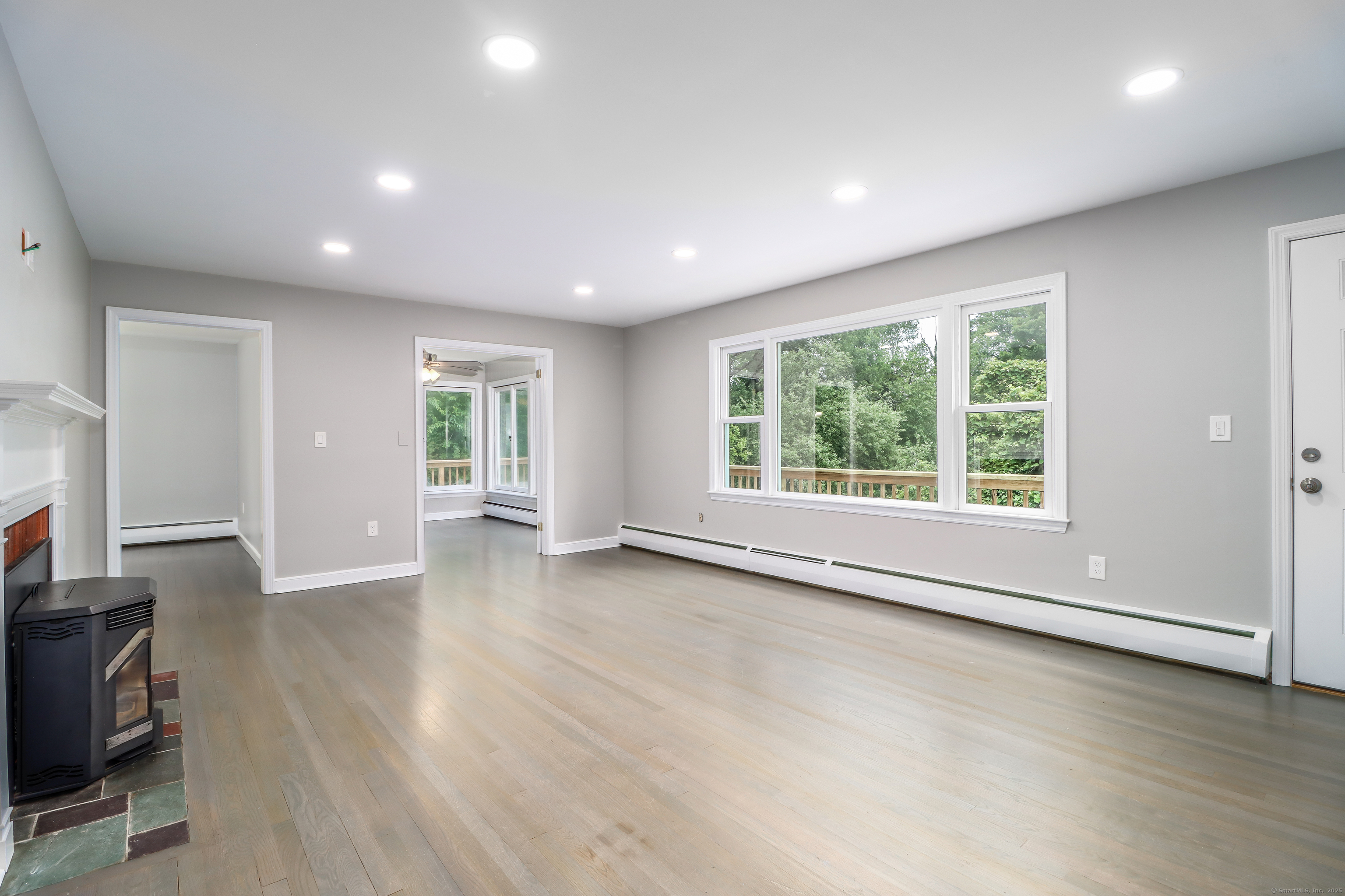 22 Lonetown Road Redding, CT 06896 - Photo 7 of 37 an empty room with wooden floor and windows