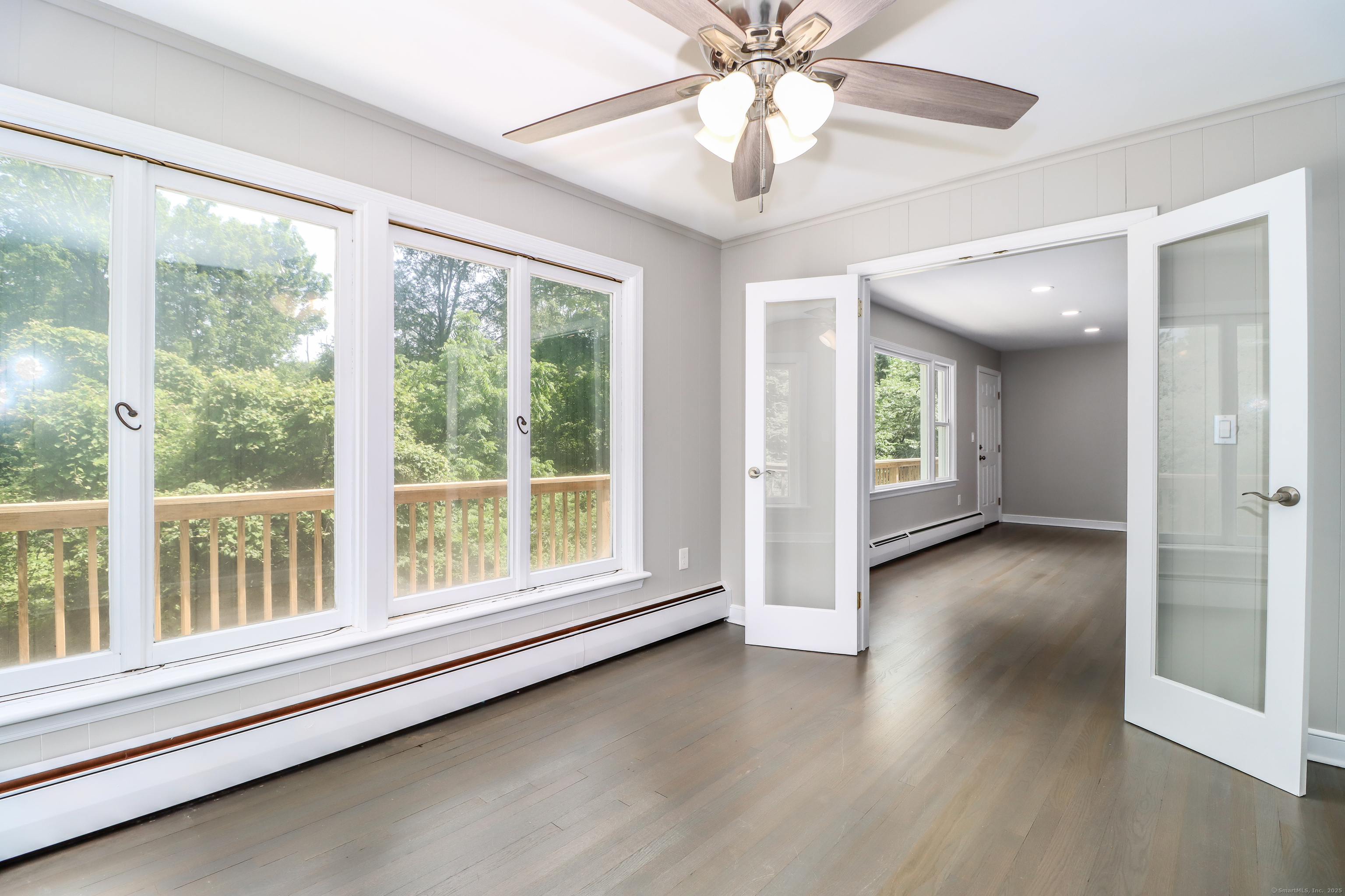 22 Lonetown Road Redding, CT 06896 - Photo 10 of 37 an empty room with wooden floor fan and windows