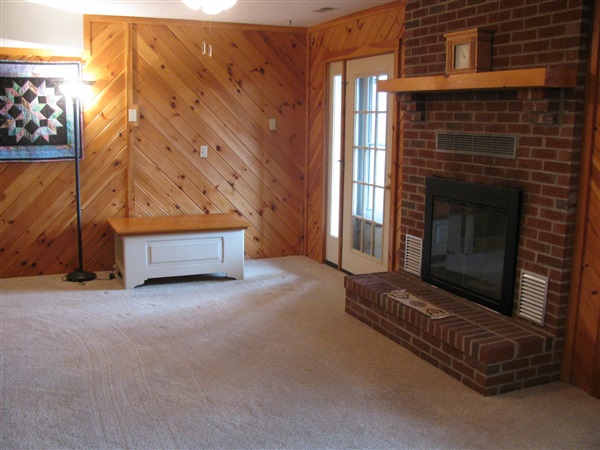 4305 Supinlick Ridge Road Mount Jackson, VA 22842 - Photo 19 of 30 a view of an empty room with wooden floor and a fireplace