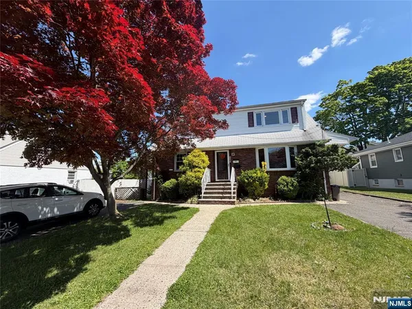 a front view of a house with a yard garden