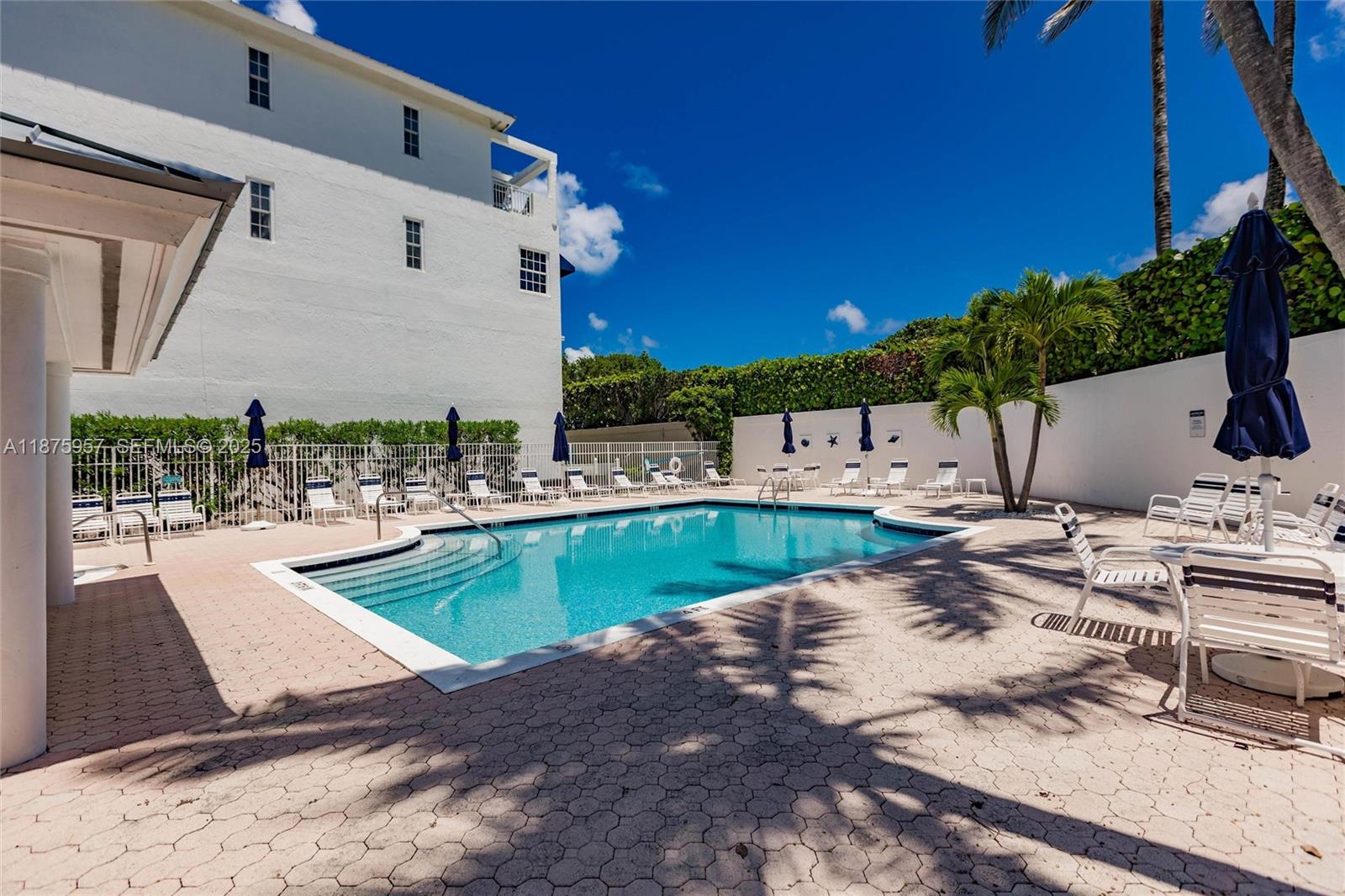 117 Ocean Key Way Jupiter, FL 33477 - Photo 14 of 58 a view of a swimming pool with a patio