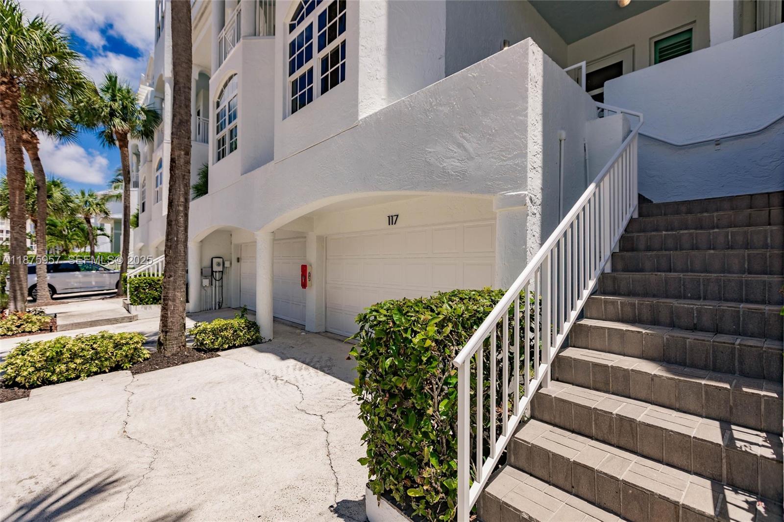 117 Ocean Key Way Jupiter, FL 33477 - Photo 17 of 58 a view of a white house with a small yard and potted plants