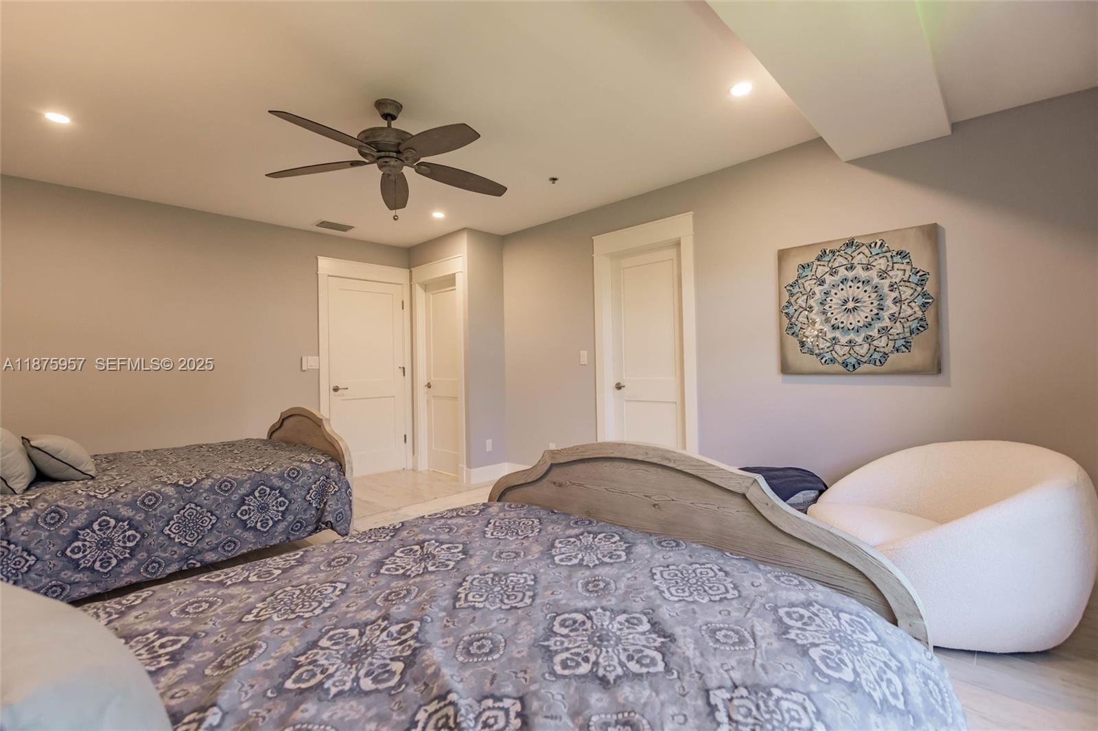 117 Ocean Key Way Jupiter, FL 33477 - Photo 23 of 58 a bedroom with a large bed and a chandelier