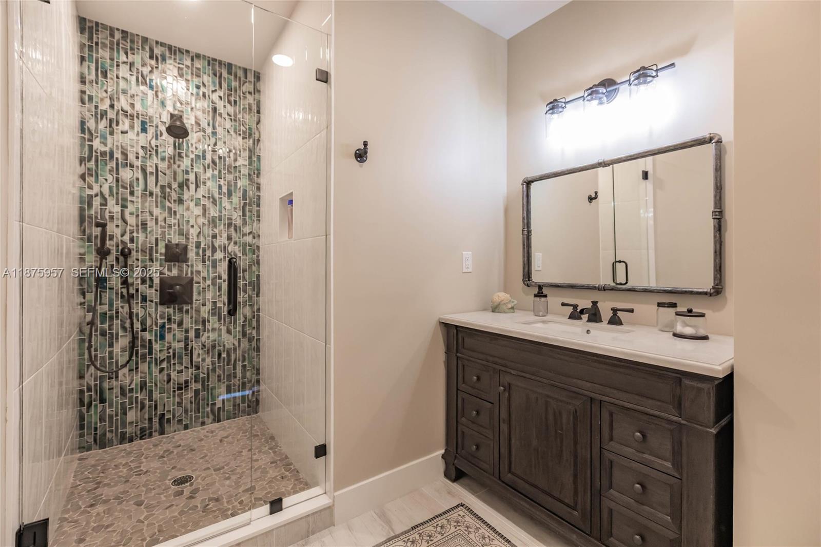 117 Ocean Key Way Jupiter, FL 33477 - Photo 30 of 58 a bathroom with a double vanity sink mirror and shower