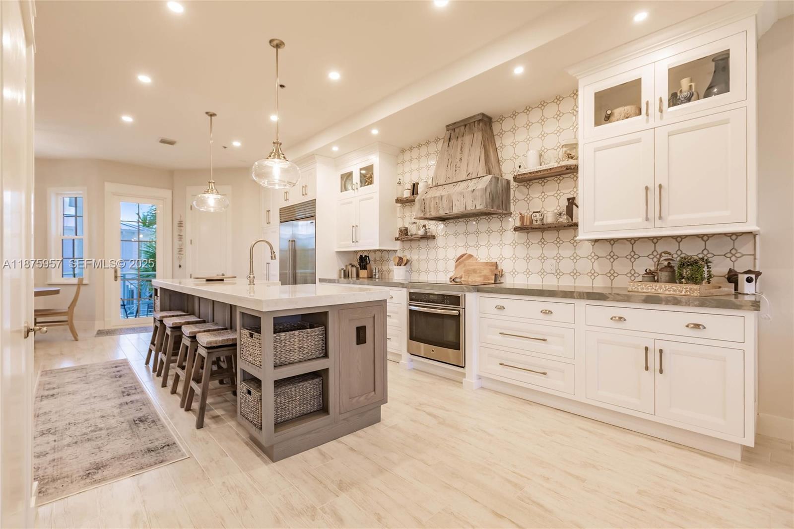 117 Ocean Key Way Jupiter, FL 33477 - Photo 40 of 58 a kitchen with stainless steel appliances kitchen island granite countertop a large counter top a sink stainless steel appliances and cabinets