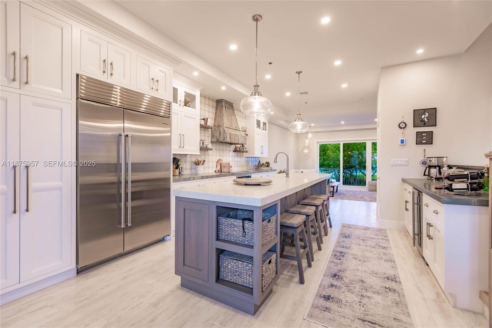 117 Ocean Key Way Jupiter, FL 33477 - Photo 41 of 58 a kitchen with kitchen island granite countertop a sink a counter and stainless steel appliances