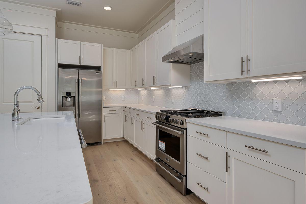430 Redbud Ln Inlet Beach Inlet Beach, FL 32461 - Photo 17 of 50 a kitchen with stainless steel appliances white cabinets and a sink