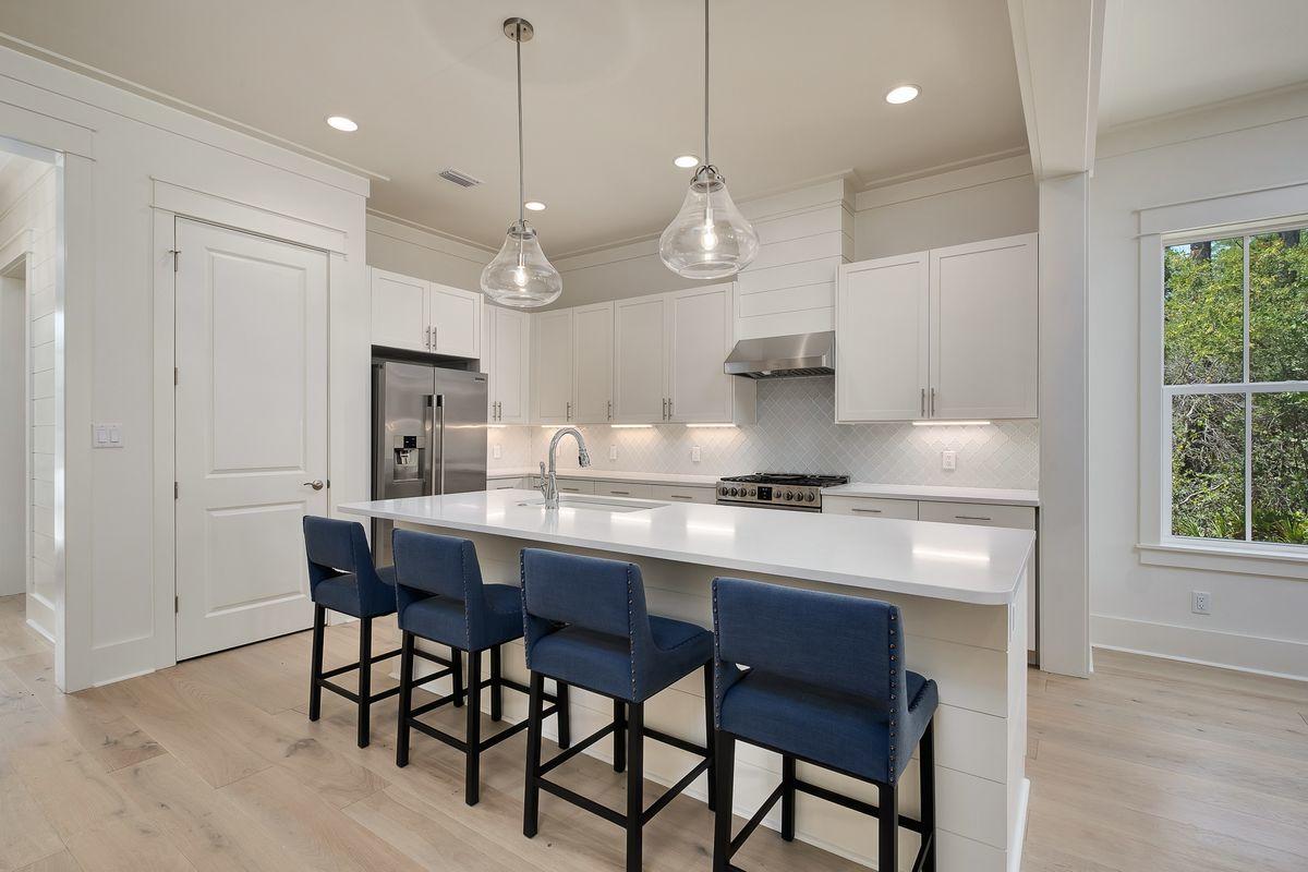 430 Redbud Ln Inlet Beach Inlet Beach, FL 32461 - Photo 3 of 50 a kitchen with stainless steel appliances granite countertop a sink a stove a table and chairs