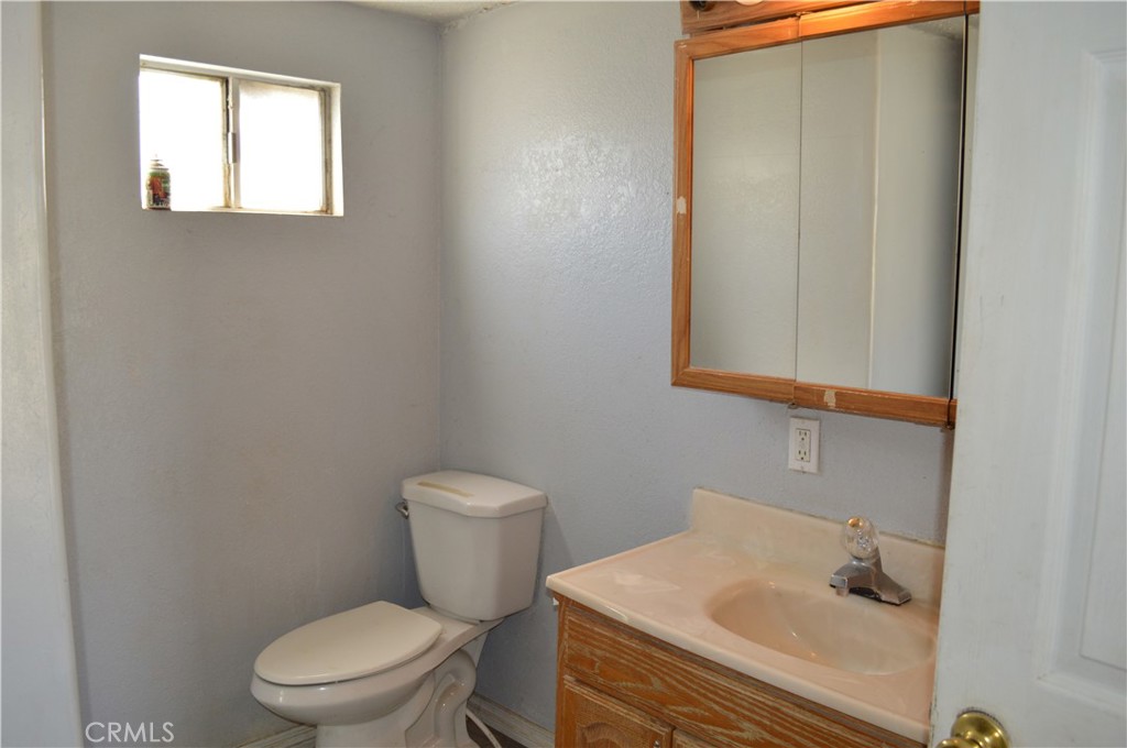 51901 Maxine Avenue Cabazon, CA 92230 - Photo 17 of 25 a white toilet sitting next to a bathroom sink