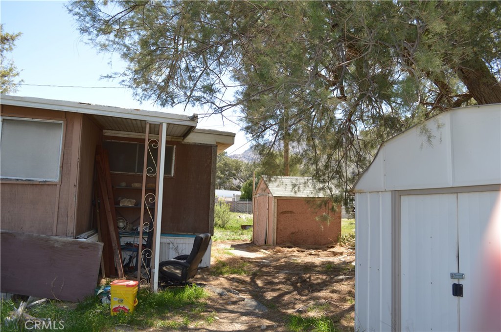 51901 Maxine Avenue Cabazon, CA 92230 - Photo 21 of 25 a view of a house with a yard garage and a tree