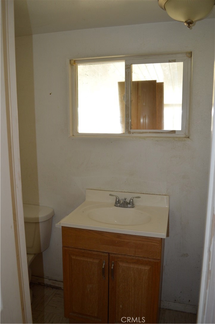 51901 Maxine Avenue Cabazon, CA 92230 - Photo 9 of 25 a bathroom with a sink a vanity and a toilet