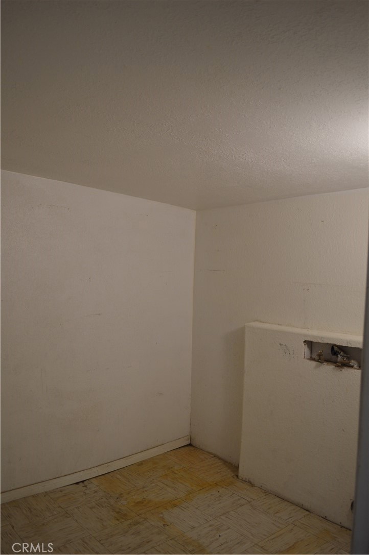 51901 Maxine Avenue Cabazon, CA 92230 - Photo 10 of 25 an empty room with a wooden floor and white door